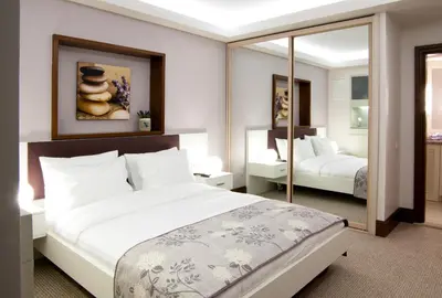 a bedroom with a large bed and a mirror at 116 Residence in Istanbul