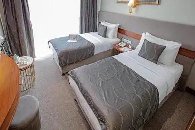a hotel room with two beds and a window at Nowy Efendi Hotel - Special Category in Istanbul