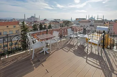 a balcony with a table and chairs and a view of a city at Nowy Efendi Hotel - Special Category in Istanbul