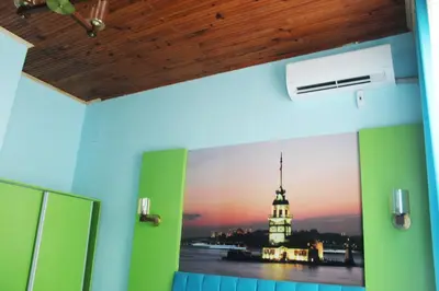 a room with a picture of a building on the wall at HOTEL MİKLAGORD in Istanbul