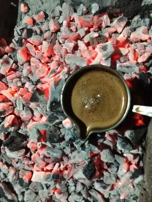 a cup of coffee sitting on a table with crystals at Hotel Wiva in Istanbul