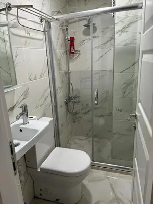 a bathroom with a shower and a toilet and a sink at Hotel Wiva in Istanbul