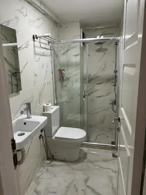 a bathroom with a shower and a toilet and a sink at Hotel Wiva in Istanbul