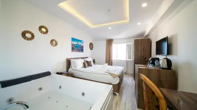 a bedroom with a bed and a tub in a room at Zeugma Hotel Sultanahmet in Istanbul