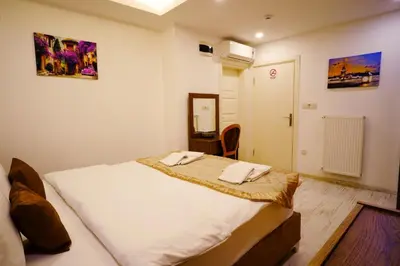 a bedroom with a bed with two towels on it at Zeugma Hotel Sultanahmet in Istanbul