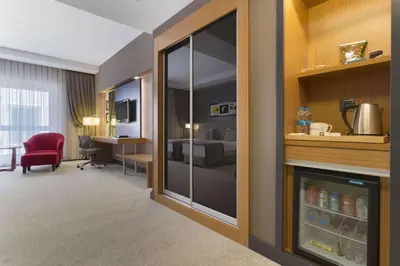 a room with a hotel room with a living room at Ramada Plaza By Wyndham Izmit in Kocaeli