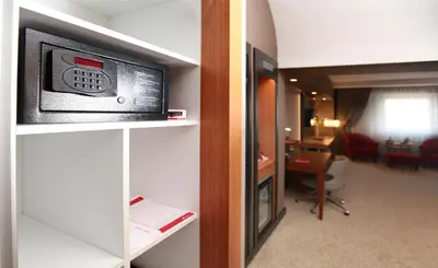 a hotel room with a television on a wall at Ramada Plaza By Wyndham Izmit in Kocaeli
