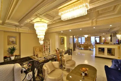 a large lobby with chairs and tables in a building at Yılsam Sultanahmet Hotel in Istanbul