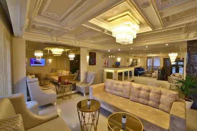 a living room with a couch and tables and chairs at Yılsam Sultanahmet Hotel in Istanbul