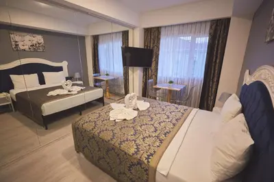 a hotel room with two beds with towels on them at Albatros Hagia Sophia Hotel in Istanbul