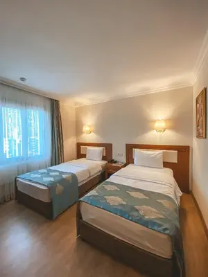 a hotel room with two beds and a window at Premier Vista Hotel in Silivri