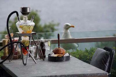 a sandwich on a table with a bird in the background at Zimmer Bosphorus Hotel in Istanbul
