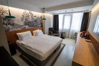 a bedroom with a bed and a desk and a tv at Zimmer Bosphorus Hotel in Istanbul