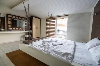 a large white bed in a room with a window at Element Suites in Istanbul