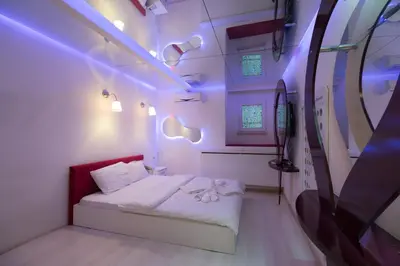 a bedroom with a bed with purple lights on it at Element Suites in Istanbul