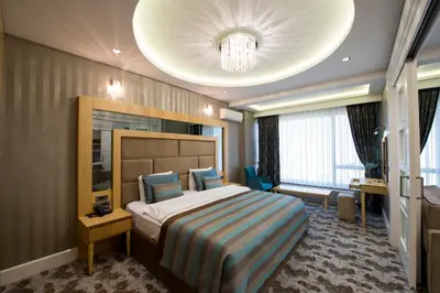 a hotel room with a bed and a chandelier at The Berussa Hotel in Bursa
