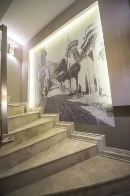 a mural on the wall of a building with stairs at The Berussa Hotel in Bursa