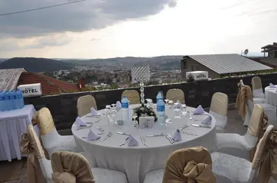 a white table with white chairs and a table with a view at The Berussa Hotel in Bursa