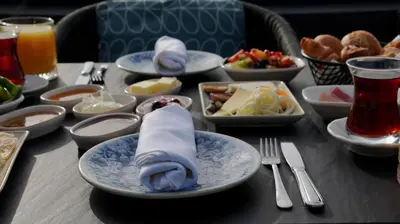 a table topped with plates and bowls of food at Adahan DeCamondo Pera, Autograph Collection in Istanbul