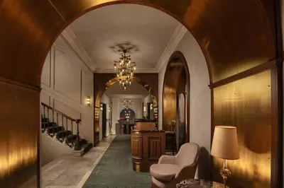 a hallway with an archway with a table and chairs at Adahan DeCamondo Pera, Autograph Collection in Istanbul