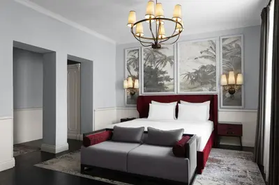 a bedroom with a bed and a couch and a chandelier at Adahan DeCamondo Pera, Autograph Collection in Istanbul