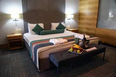 a hotel room with a bed and a table with a tray of fruit at Hotel Yayoba in Tekirdag