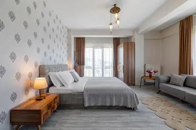 a bedroom with a large bed and a couch at Lagun Palas in Yalova