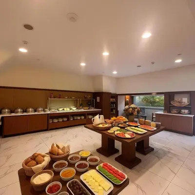 a large kitchen with several tables filled with food at Taxim Express Bosphorus Hotel in Istanbul