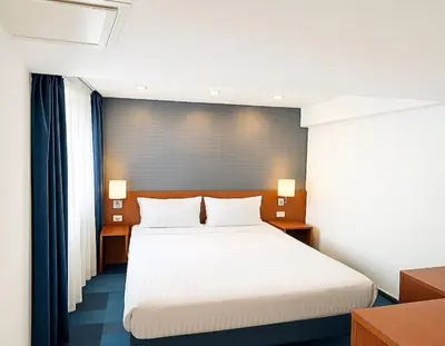 a bedroom with a white bed and two lamps at Taxim Express Bosphorus Hotel in Istanbul