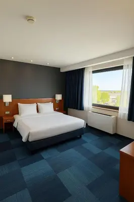 a bedroom with a large bed and a large window at Taxim Express Bosphorus Hotel in Istanbul