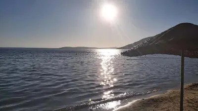 a body of water with the sun shining on it at Hotel Yasemin in Erdek