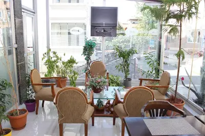 a room with a table and chairs and plants at Anka Premium Hotel in Istanbul