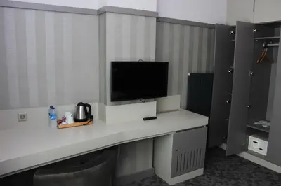 a room with a desk with a television on it at Anka Premium Hotel in Istanbul