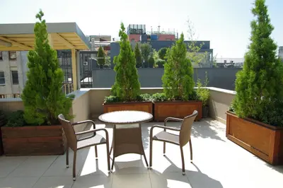 a patio with a table and chairs on a roof at Pera Residence in Istanbul