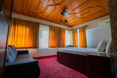a bedroom with a large bed and a couch at Gulliver Mansion Hotel in Istanbul