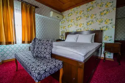 a bedroom with a bed and a chair at Gulliver Mansion Hotel in Istanbul