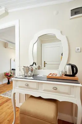 a white dressing table with a mirror on it at Mataraci Konak in Istanbul