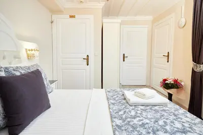 a bedroom with a white bed with a towel on it at Mataraci Konak in Istanbul