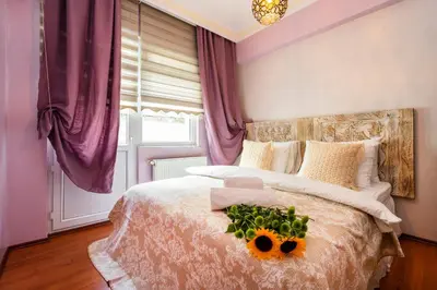 a bedroom with a bed with flowers on it at Ajda Haus Nisantasi in Istanbul