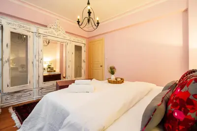 a bedroom with a large white bed and a mirror at Ajda Haus Nisantasi in Istanbul