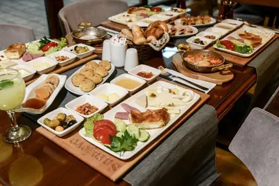 a long table with many plates of food on it at Sarajevo Suit Hotel in Kocaeli