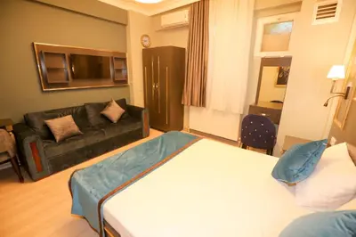 a hotel room with a bed and a couch at Grand Moon Hotel Suites in Istanbul