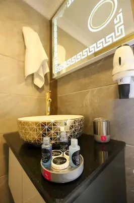 a bathroom with a counter with a sink and a mirror at Grand Moon Hotel Suites in Istanbul