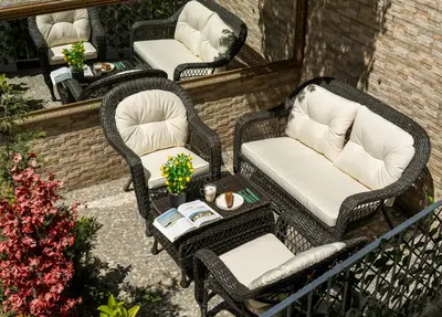 three wicker chairs and a table on a patio at Royan Suites in Istanbul