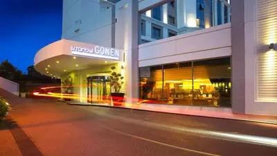 a street in front of a building at night at Istanbul Gonen Hotel in Istanbul