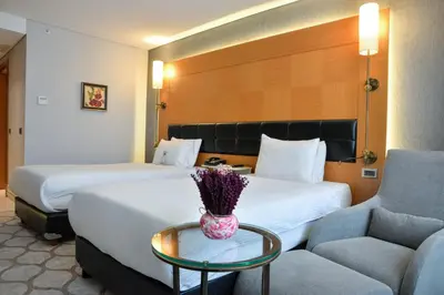 a hotel room with two beds and a table at Istanbul Gonen Hotel in Istanbul