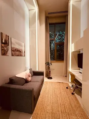 a living room with a couch and a window at Ortakoy Aparts in Istanbul