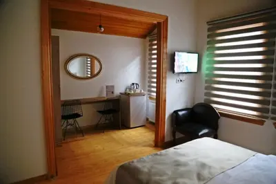 a bedroom with a bed and a desk with a chair at Belizia Hotel in Istanbul