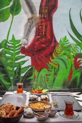 a table with a buffet of food and a rabbit mural at The Westist Hotel & Spa - Special Category in Istanbul