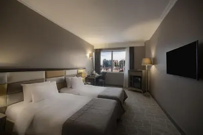 a hotel room with two beds and a television at Taksim Square Hotel in Istanbul